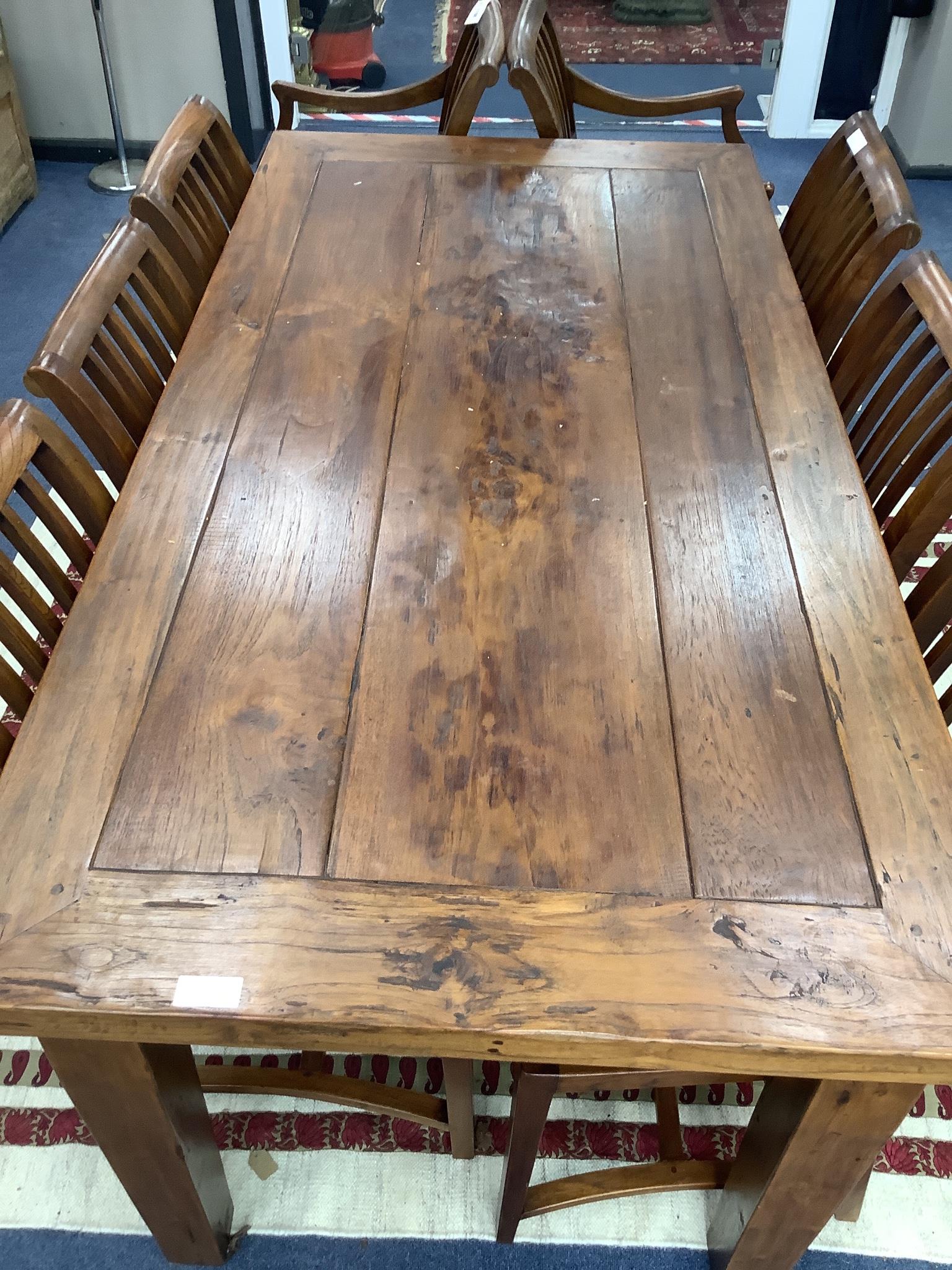 An 18th century style teak rectangular topped dining table and eight chairs